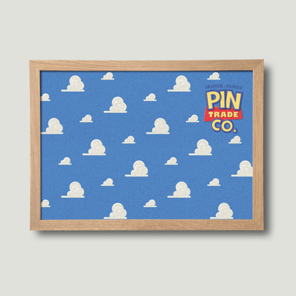 landscape version of wooden framed pin board with blue sky and clouds design in background. Toyistory themed graphic.