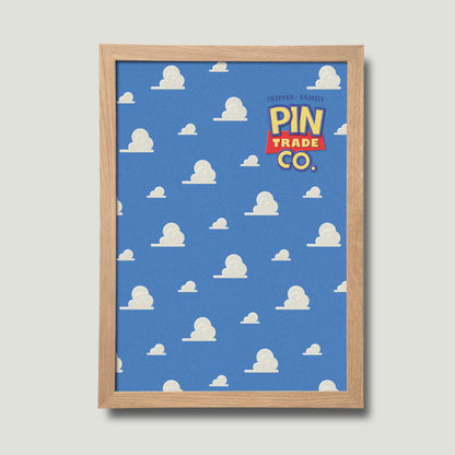 framed in natural wood, cork pin trading board displays andys room wallpaper in the background.